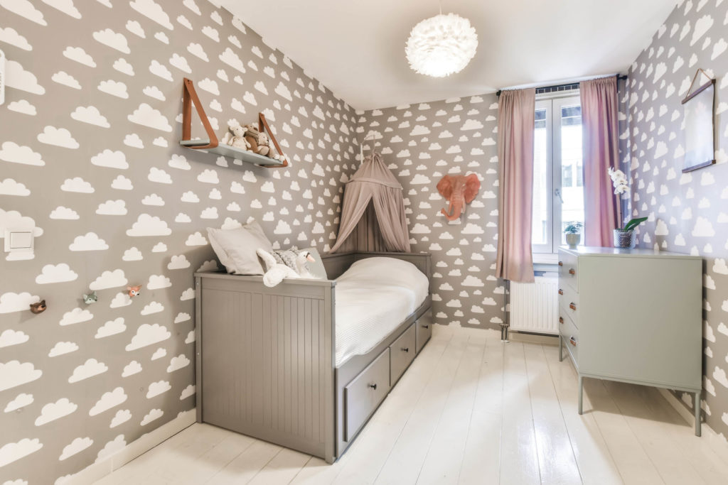 Interior of a cozy children's room with wallpaper 