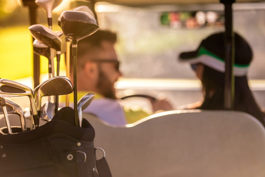 a couple riding a golf cart