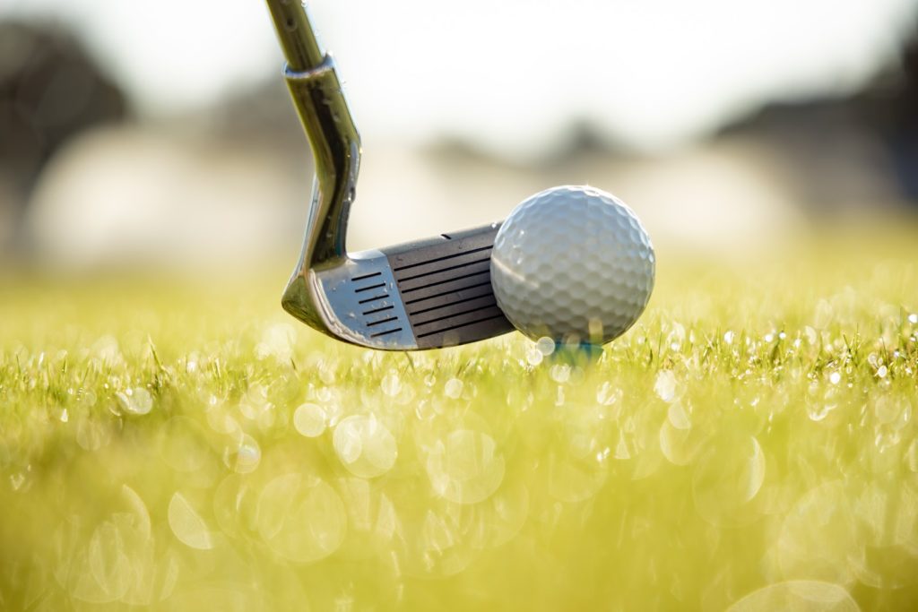 a golf club and ball