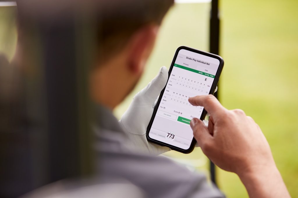a golfer checking his score