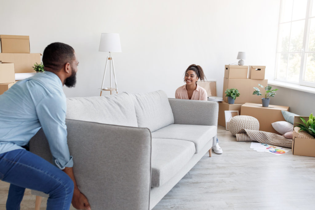 couple rearranging furniture