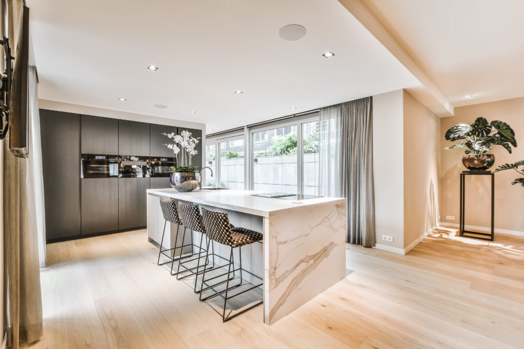 Luxurious kitchen with marble waterfall island
