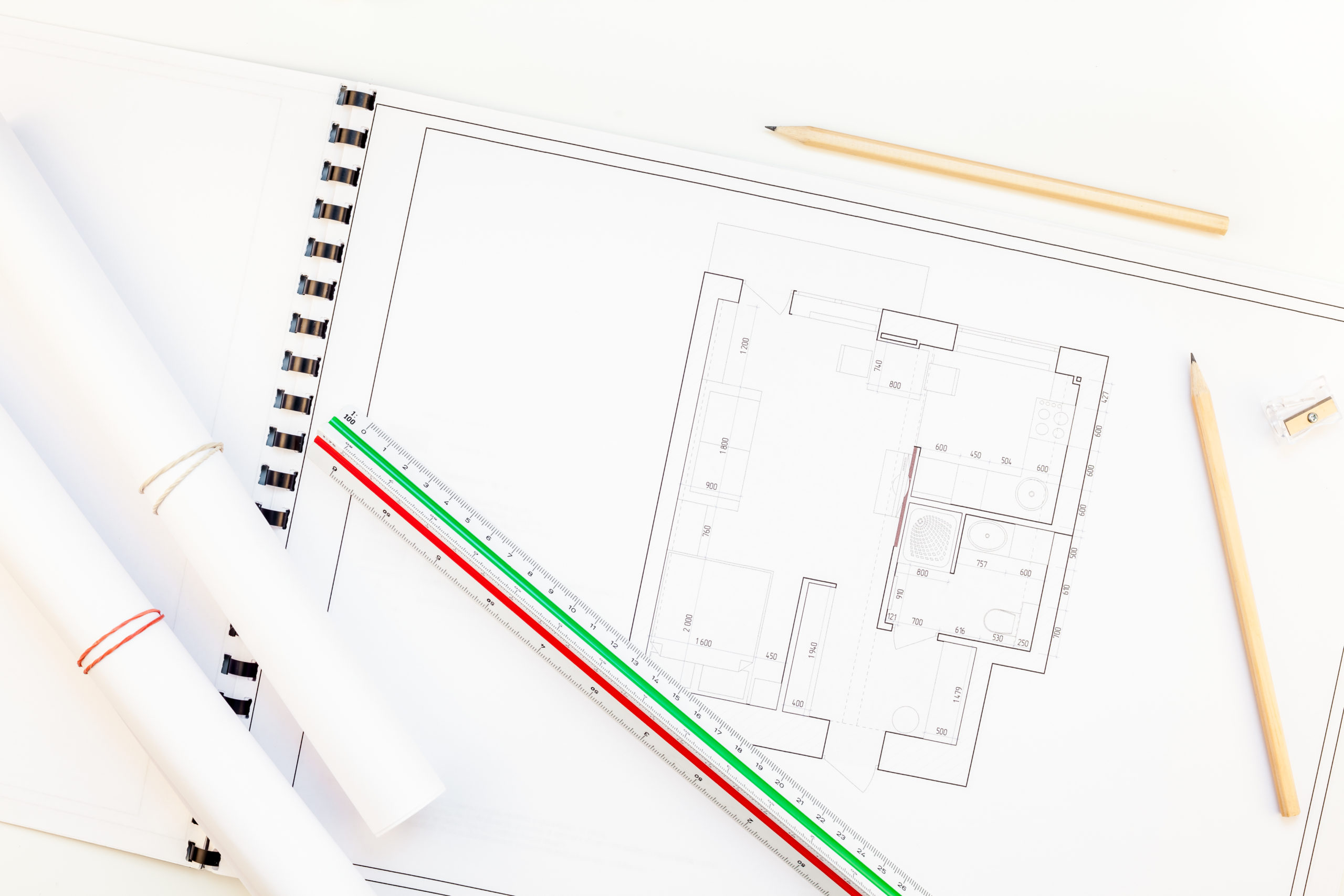 Creative flat lay overhead top view blueprints architectural flat project plan and office supplies on decorator white table workspace with swatches tools and equipment background copy space concept
