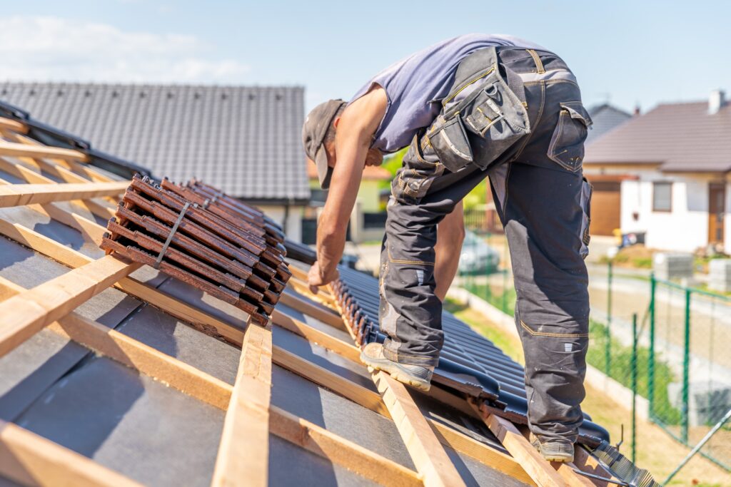 A roofer installing roof tiles