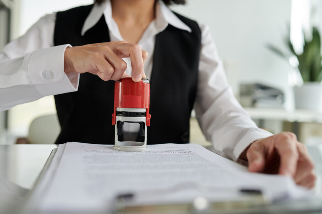 A clerk stamping a permit