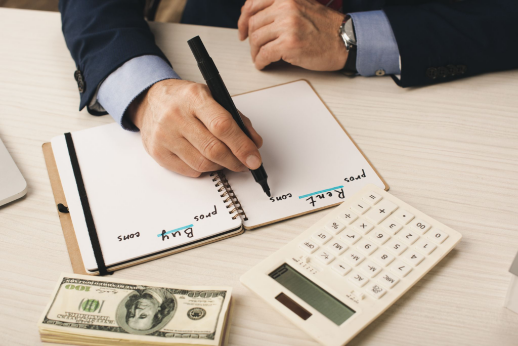 A man writing a pros and cons list